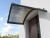 robelit-daszek-aluminiowy-lukowy-brazowy-plus-poliweglan-dymny-zdjecie-realizacji.webp